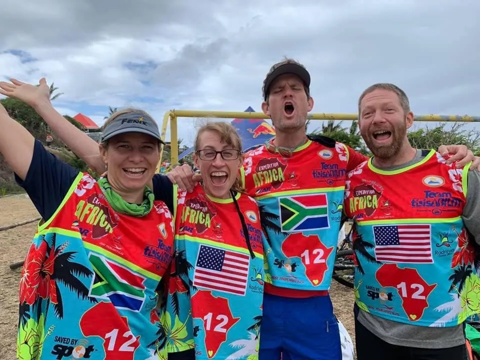 Four Team thisABILITY racers in matching team 12 race shirts cheering
