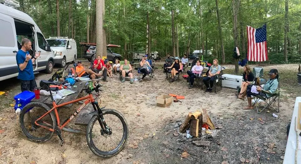 Mountain bike parked at a clinic camp with participants in the background