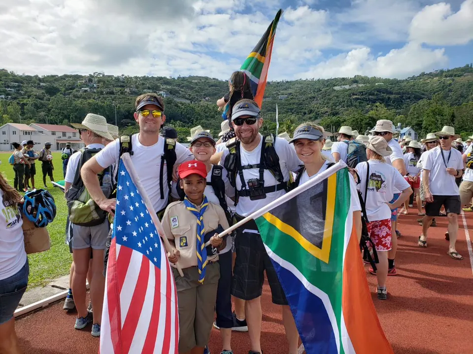 Team thisABILITY members holding American and South African flags at the Expedition Africa opening parade